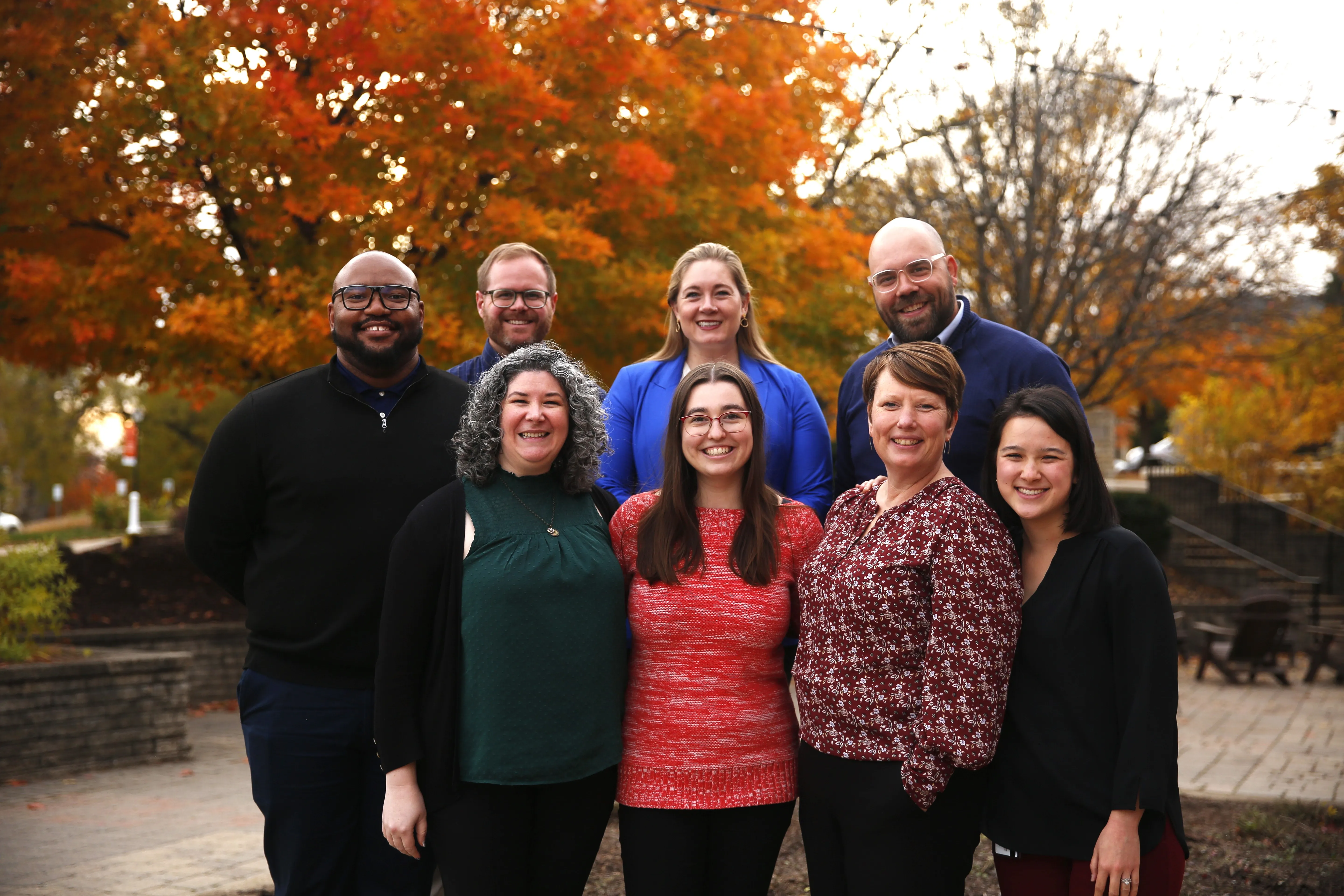 Eight staff members smiling together