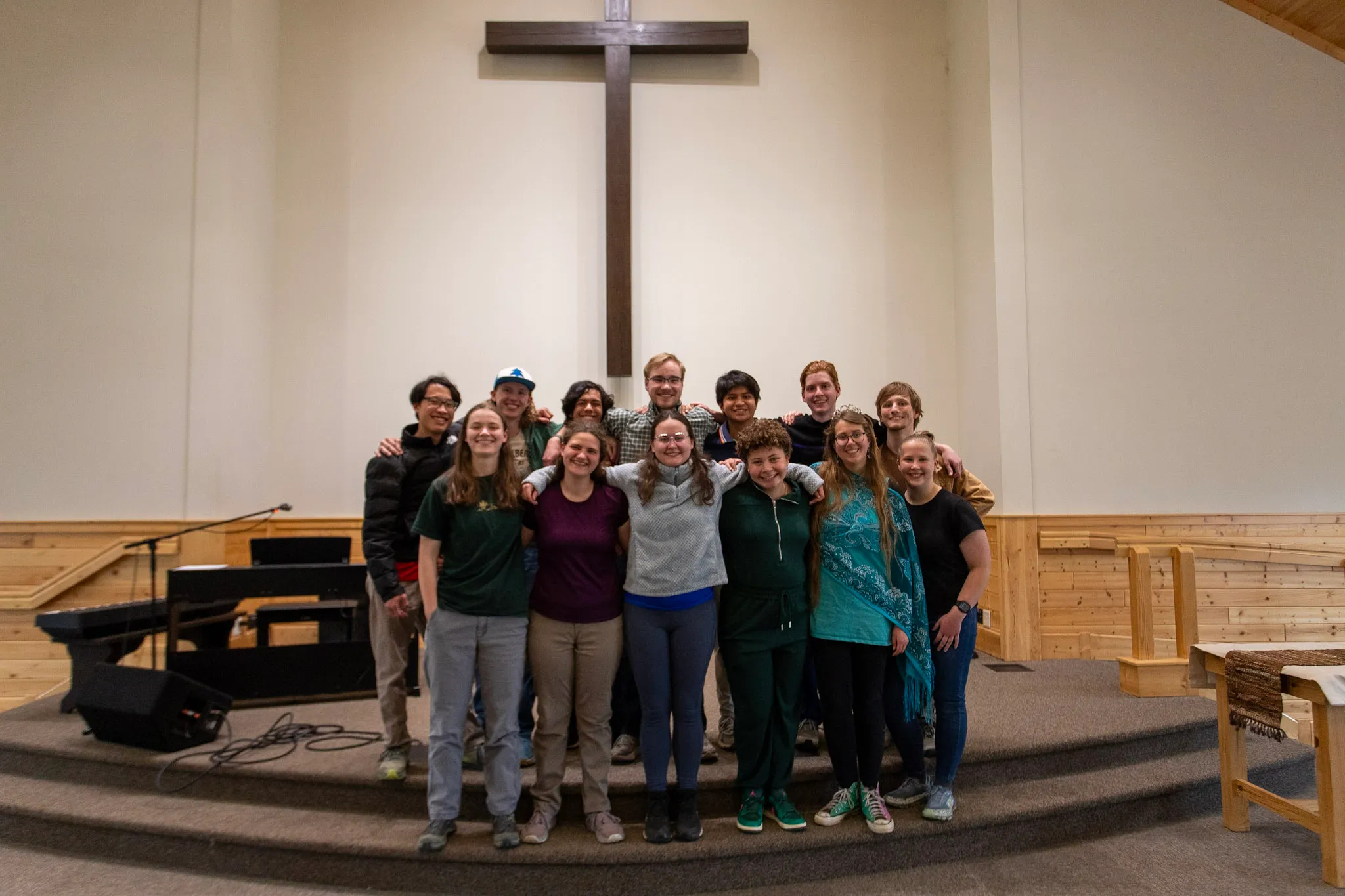 A group of students standing on stage in the chapel