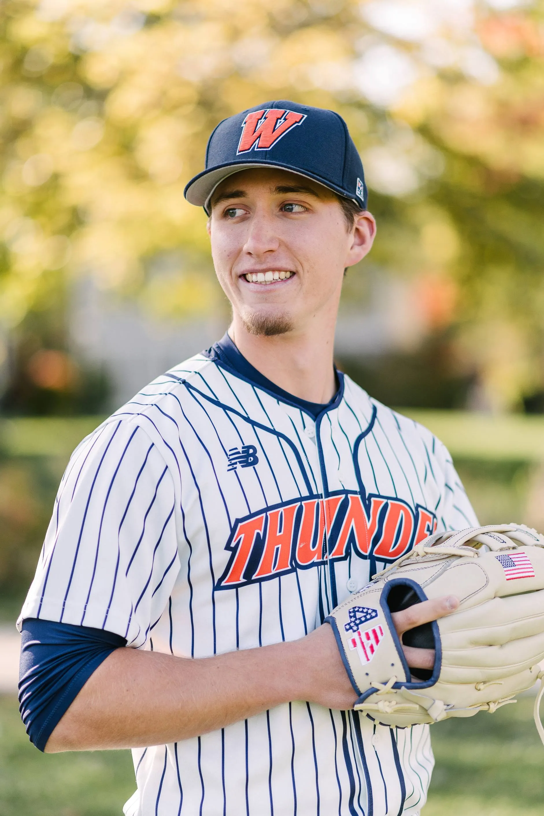 Student poses with baseball mitt