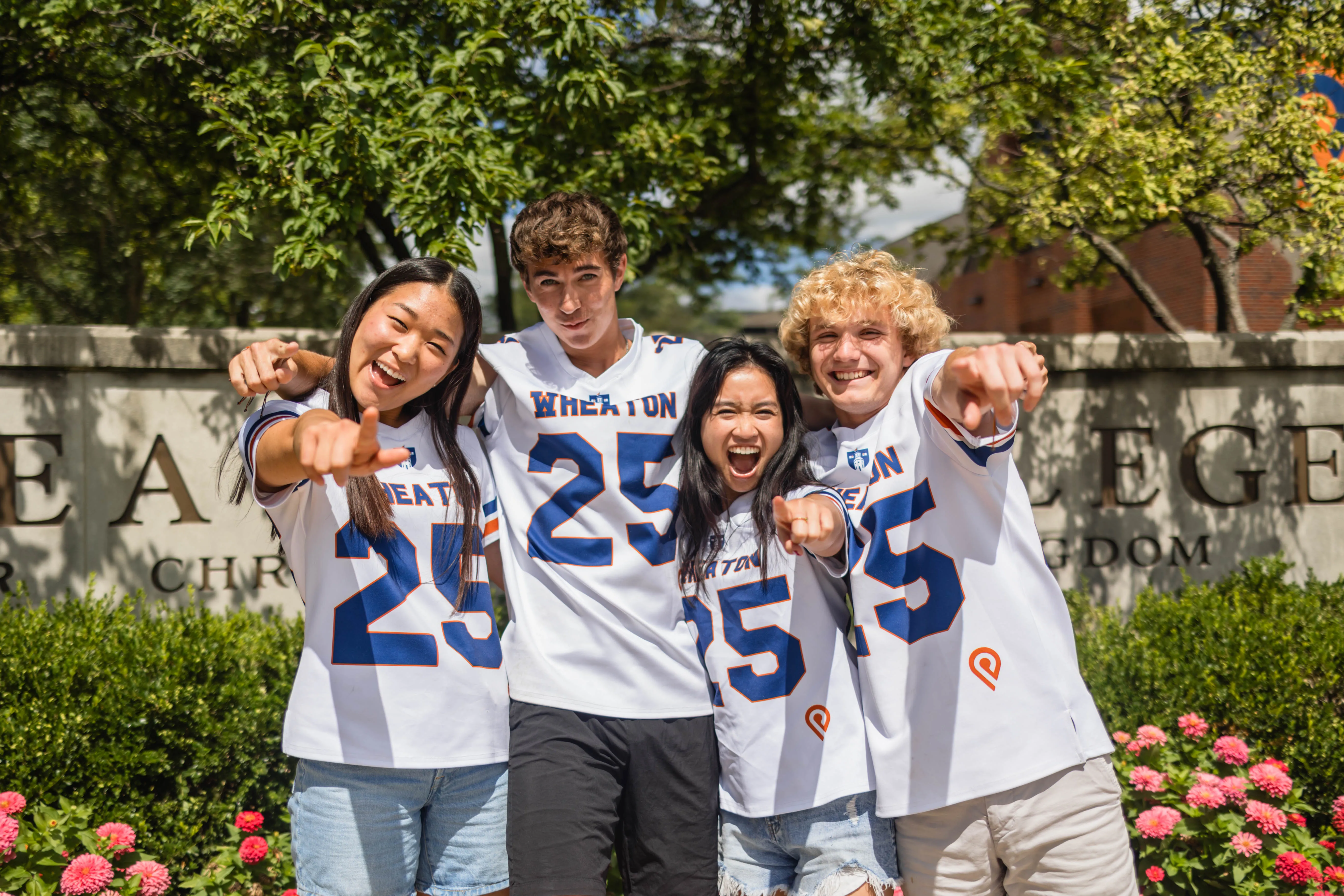 Students pointing into camera