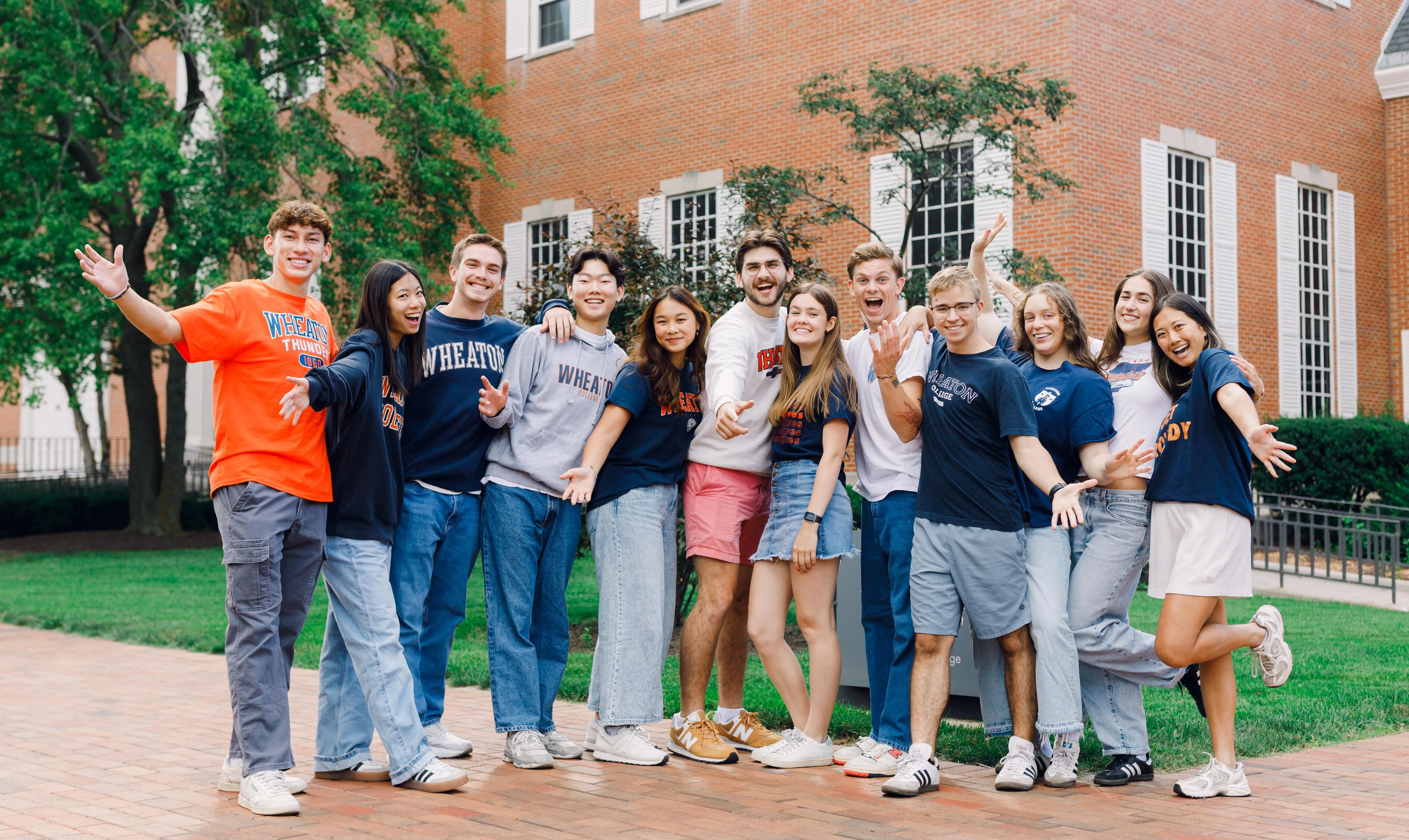 Students smiling in front of Bily Graham Hall.