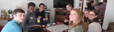 English Students playing a board game together