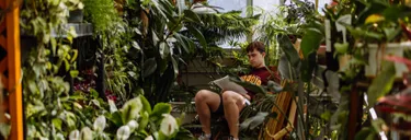 Wheaton Student studying in the Greenhouse