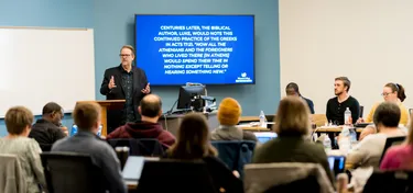 Professor lecturing to grad students