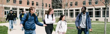Students walking on campus and laughing