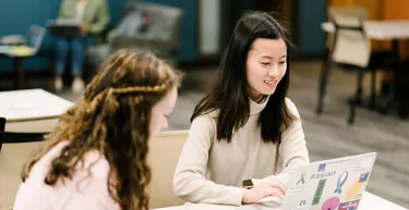 Grad students working together on laptop
