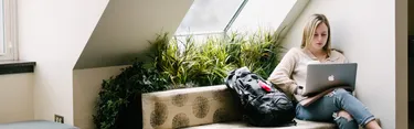 Student on laptop in lounge