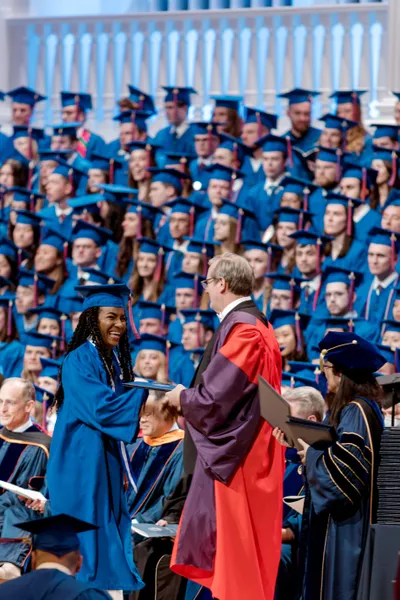 Philip Ryken presenting diploma to graduate at Commencement