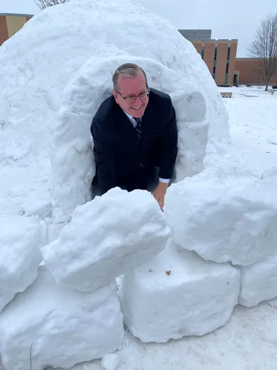 Dr. Ryken in an Igloo Students Made in the Quad
