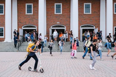 student scooters after chapel