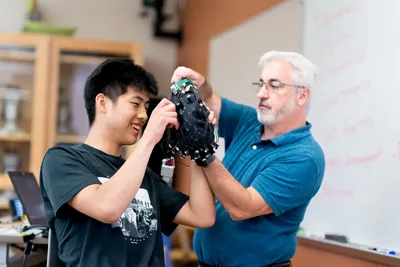 High school student at Wheaton College science class wearing a headset
