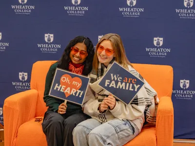 Students with Family Sign