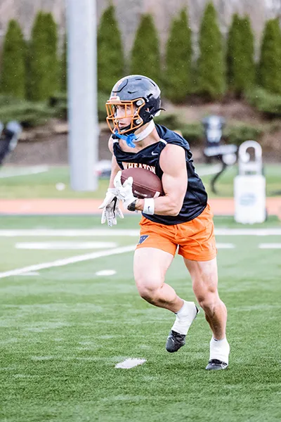 A football player running in the field.