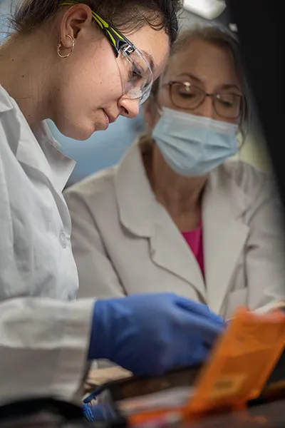 Two female performing an experiment