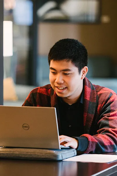 A Male student studying with laptop