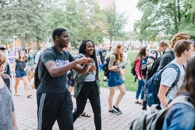 two students walking in crowd at wheaton