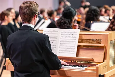 A group of student playing different instrument on stage