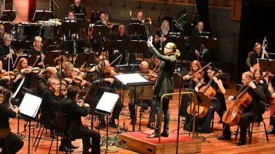 An orchestra performing on stage