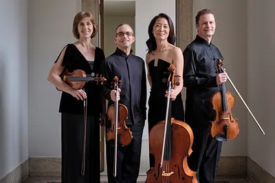 Four people standing holding their instrument