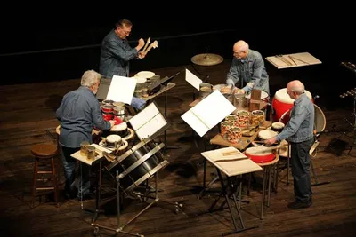 Four men playing percussion instruments
