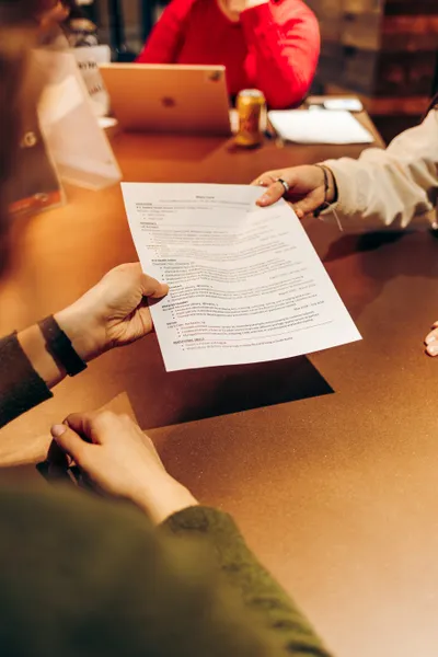Two hands holding a resume template