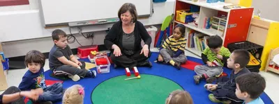 teacher with students sitting in a circle