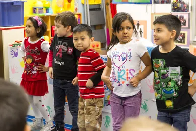 Young students colorfully dressed and in a line