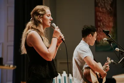 two students on Edman stage leading worship