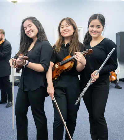 Three Wheaton College Conservatory of Music Students with Instruments