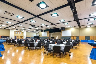 A spacious banquet hall with tables and chairs