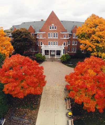 A building surrounded by trees with orange and yellow leaves