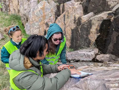 Professor Maniero with Environmental Science students doing research in the field