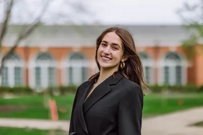 Annie Clare Wilson smiling at the camera in business formal.