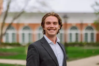 Benjamin Maher smiling at the camera in business formal.