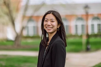 Corinna Choi smiling at the camera in business formal.