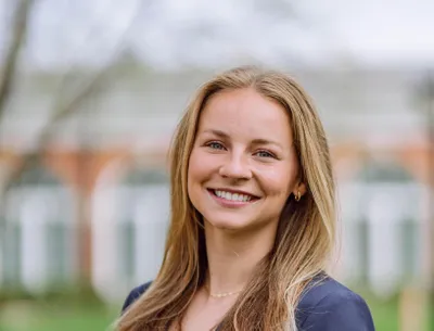 Elizabeth standing and smiling at the camera.