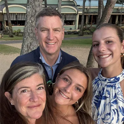Esther Baird and her family smiling at the camera on vacation.