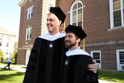 two doctoral students at graduation