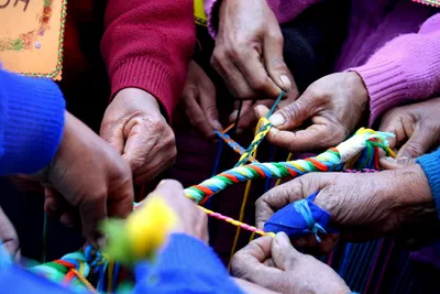 Hands twining string together