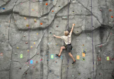 Student climbing on climbing wall
