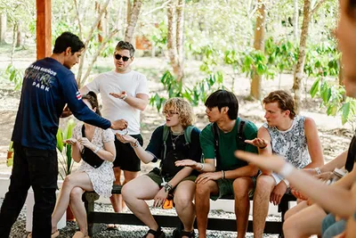 A man is giving something to other campers