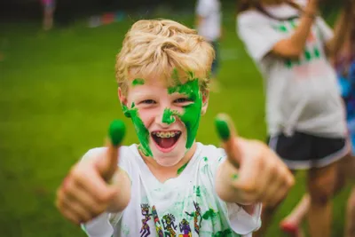 boy gives two thumbs up to camera