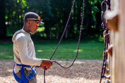 high school freshman boy rock climbing