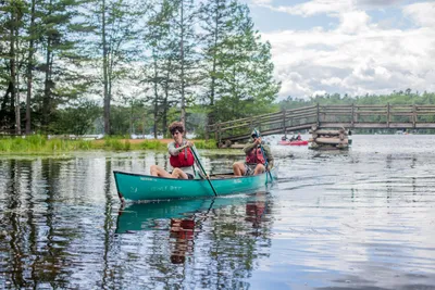 high school students canoeing down Long Lake