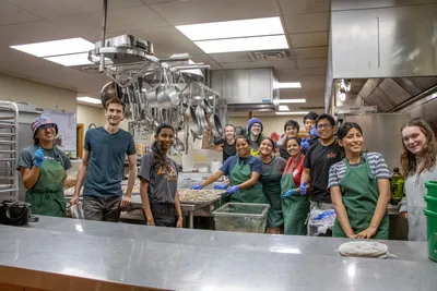 A large group of summer kitchen staff in the honeyrock kitchen