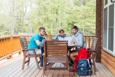 three male students studying outside on chrouser deck