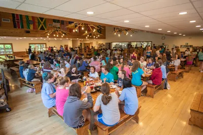 campers sitting around tables in chrouser dining hall