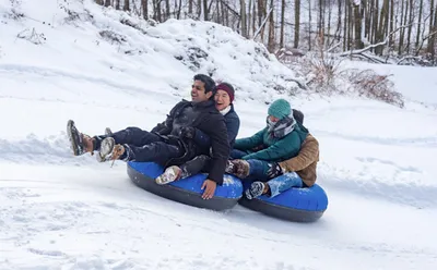 Four students snow tubing