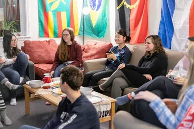 A few students sitting on sofa and talking