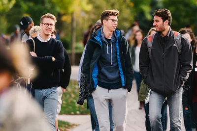 920x613 photo of pleasant happy students walking